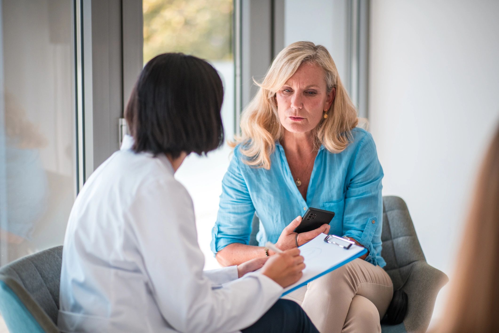 Patient and doctor in a bright wellness consultation