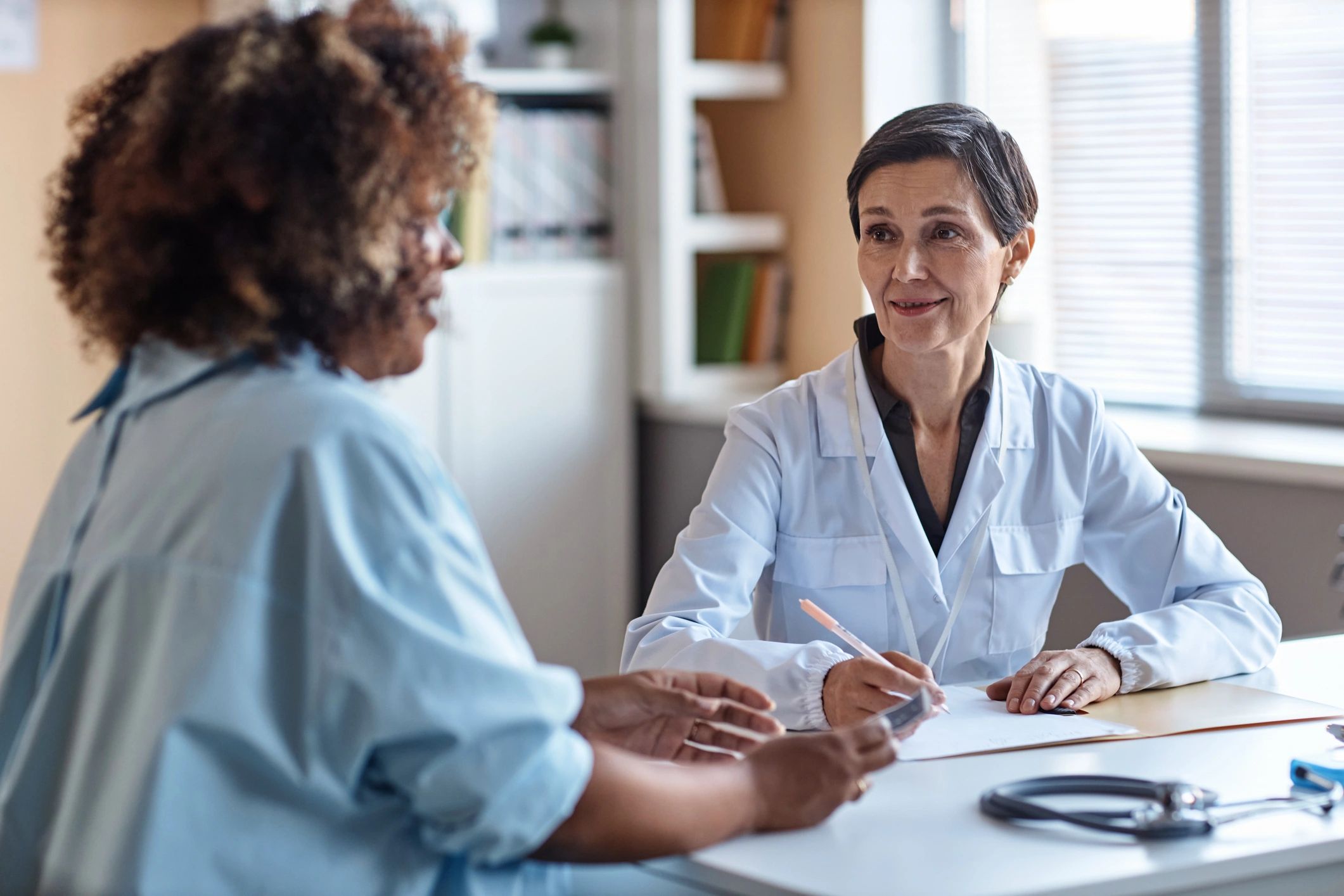 Doctor consulting with patient in a bright clinic setting